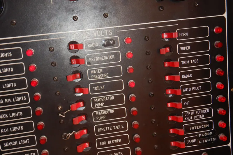 Slide: The Image of Binders labeled "Appliances," "Maint," "Genny," and "Water Maker" on a shelf, related to 1988 Camargue yacht. - 82