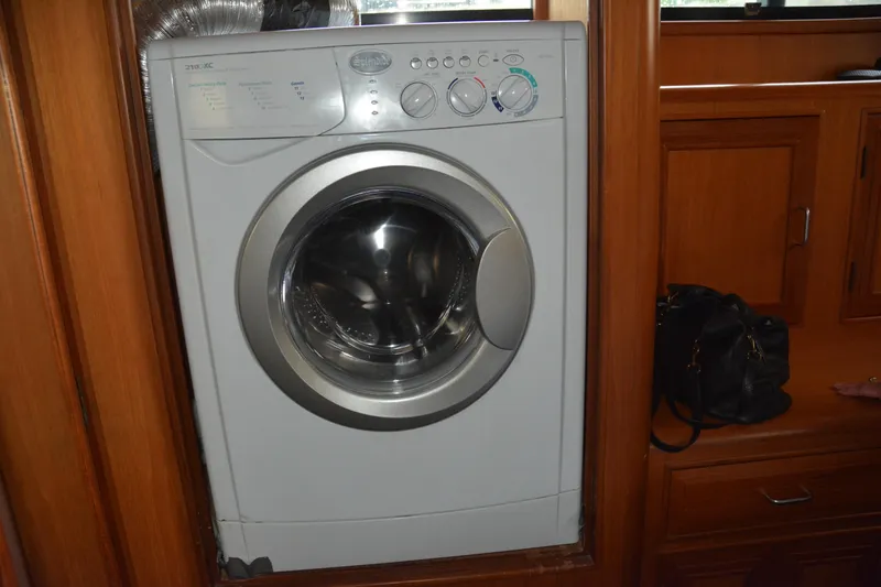 Slide: The Image of A small fishing boat with Honda motor and fishing rods docked by the shore. - 86