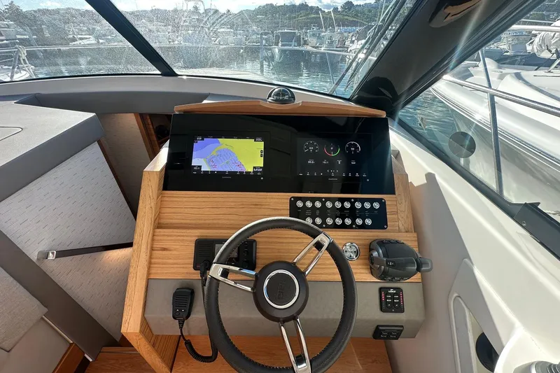 Slide: The Image of 2023 Tiara Yachts C39 Coupe helm with navigation display and controls. - 10