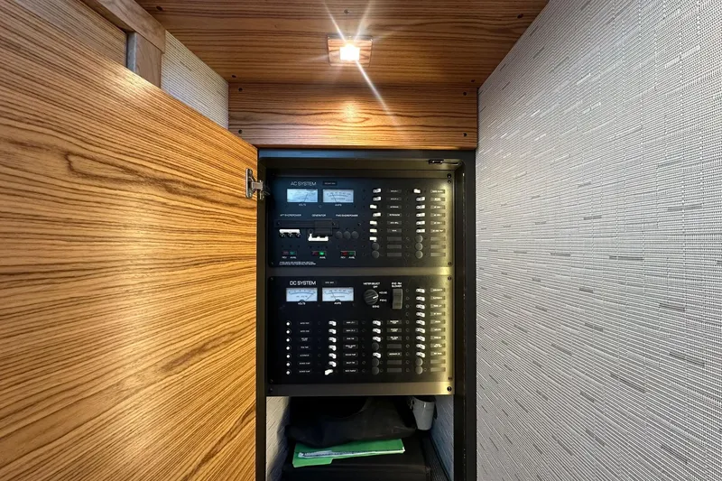 Slide: The Image of Electrical panel inside 2023 Tiara Yachts C39 Coupe, featuring AC and DC systems. - 11