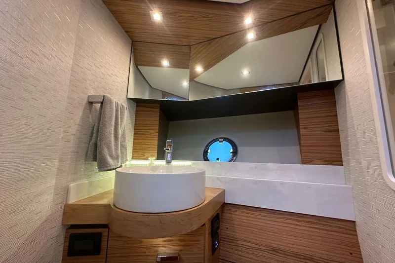 Slide: The Image of Luxurious bathroom interior of 2023 Tiara Yachts C39 Coupe with modern fixtures and wood accents. - 16