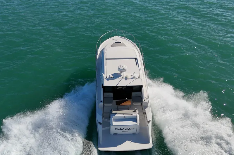 Slide: The Image of 2023 Tiara Yachts C39 Coupe cruising on open water, aerial view. - 18