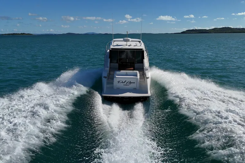 Slide: The Image of 2023 Tiara Yachts C39 Coupe cruising on open water, creating a dynamic wake. - 2