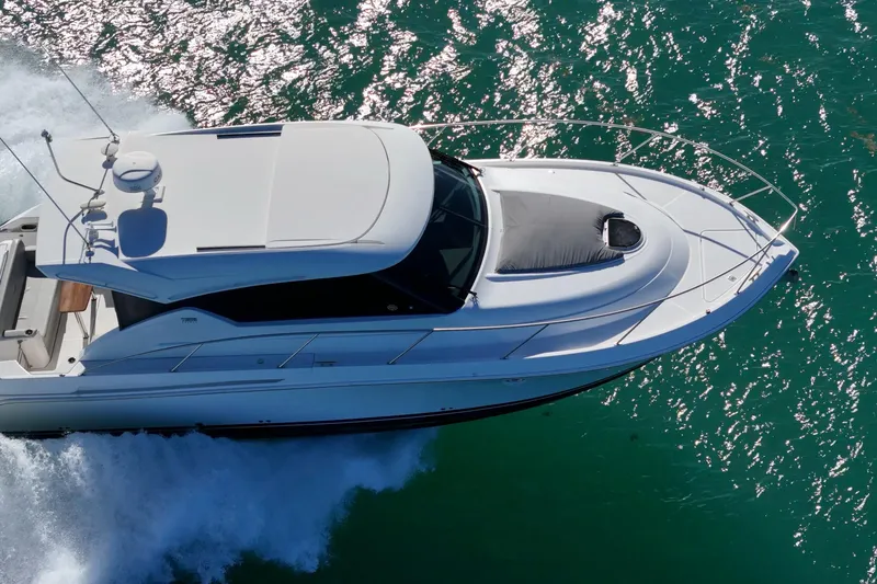 Slide: The Image of 2023 Tiara Yachts C39 Coupe cruising on sparkling turquoise water. - 20