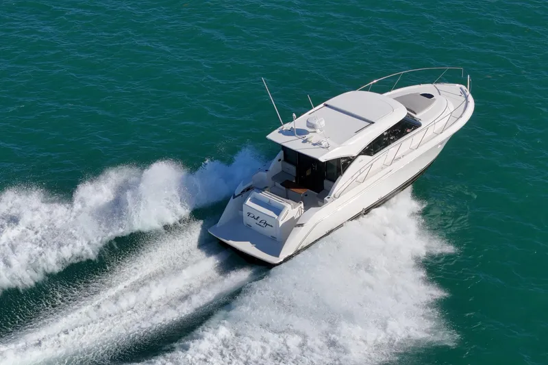 Slide: The Image of 2023 Tiara Yachts C39 Coupe cruising on open water, showcasing sleek design and performance. - 23