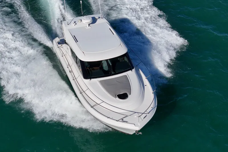 Slide: The Image of 2023 Tiara Yachts C39 Coupe cruising on turquoise waters, aerial view. - 24