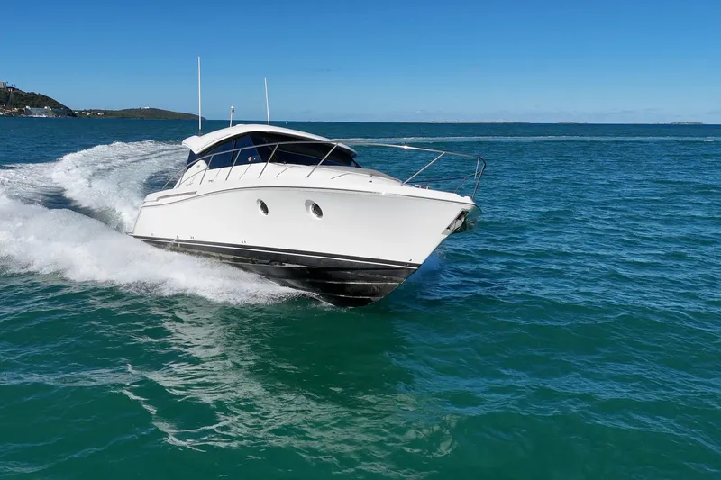 Slide: The Image of 2023 Tiara Yachts C39 Coupe cruising on open water under clear blue skies. - 27