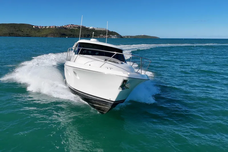 Slide: The Image of 2023 Tiara Yachts C39 Coupe cruising on clear blue waters. - 28