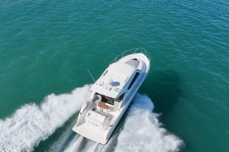 Slide: The Image of 2023 Tiara Yachts C39 Coupe cruising on open water, aerial view. - 3
