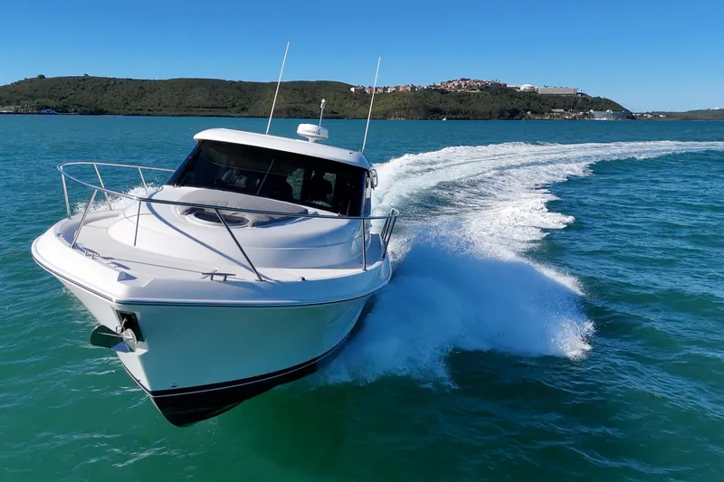 Slide: The Image of 2023 Tiara Yachts C39 Coupe cruising on clear blue water. - 30