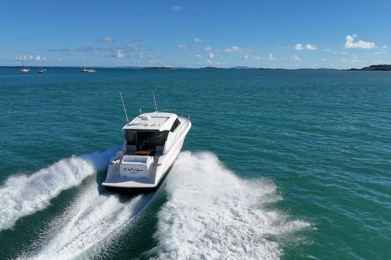 Slide: The Image of 2023 Tiara Yachts C39 Coupe cruising on open sea under clear blue sky. - 31