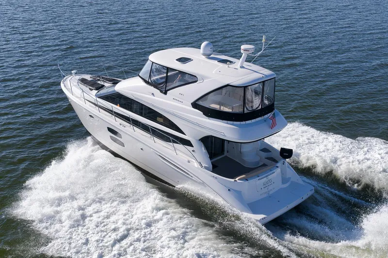Slide: The Image of 2012 Meridian 441 Sedan yacht cruising on open water, rear view. - 11