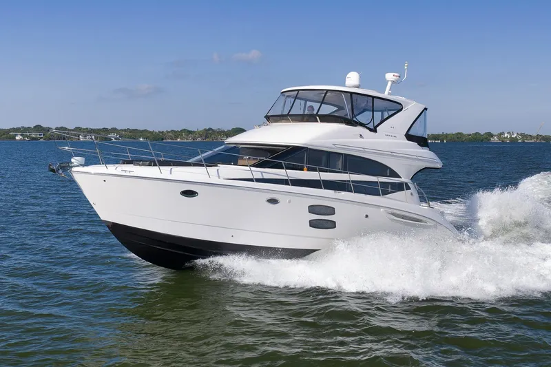 Slide: The Image of 2012 Meridian 441 Sedan yacht cruising on open water, creating waves. - 13