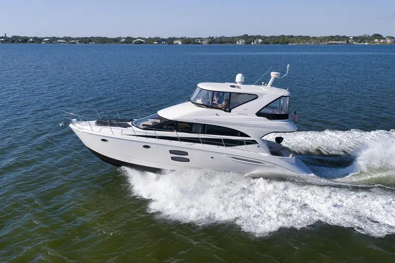 Slide: The Image of 2012 Meridian 441 Sedan yacht cruising on open water. - 14
