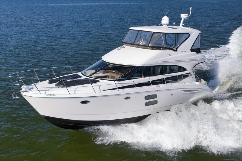 Slide: The Image of 2012 Meridian 441 Sedan yacht cruising on open water. - 15