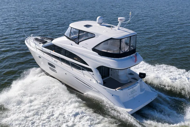 Slide: The Image of 2012 Meridian 441 Sedan yacht cruising on open water, rear view. - 19