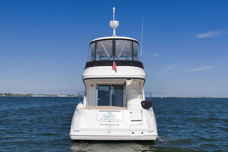 Slide: The Image of 2012 Meridian 441 Sedan yacht on open water, clear blue sky background. - 20