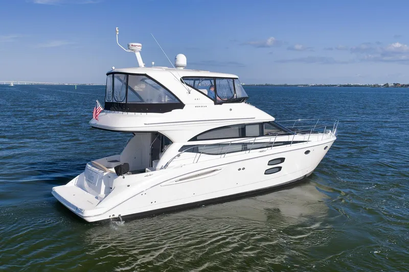 Slide: The Image of 2012 Meridian 441 Sedan yacht cruising on open water under clear skies. - 22