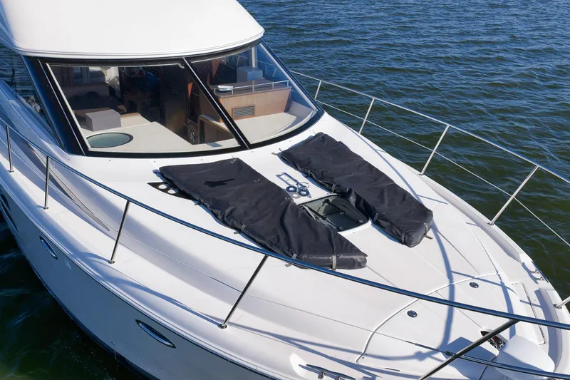 Slide: The Image of 2012 Meridian 441 Sedan yacht on water, featuring sleek design and spacious deck. - 30
