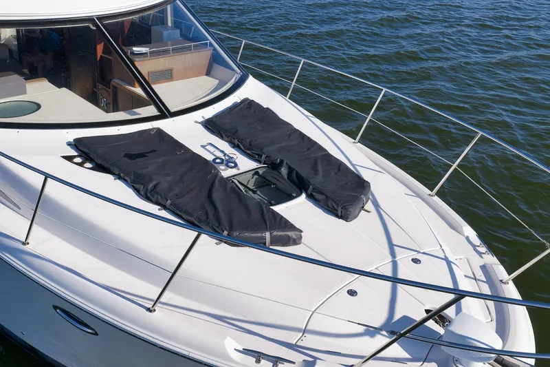 Slide: The Image of 2012 Meridian 441 Sedan yacht deck with covered sunpads on calm water. - 31
