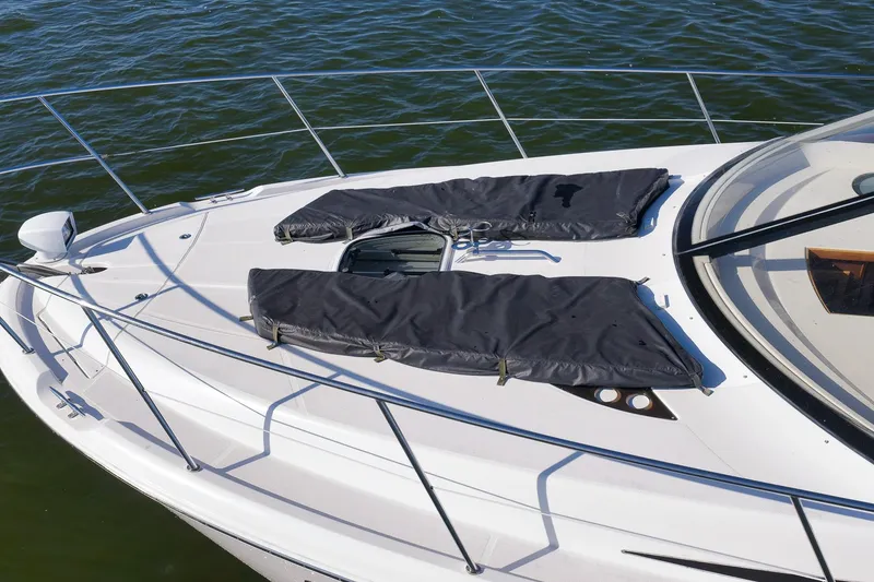 Slide: The Image of 2012 Meridian 441 Sedan yacht deck with sun pads on calm water. - 32