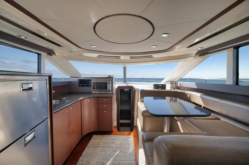 Slide: The Image of Luxurious interior of a 2012 Meridian 441 Sedan yacht with modern kitchen and seating area. - 34