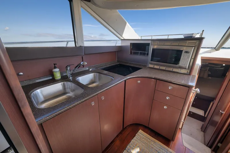 Slide: The Image of Luxurious kitchen area in a 2012 Meridian 441 Sedan yacht with dual sinks and microwave. - 43