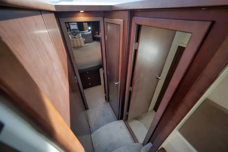 Slide: The Image of Interior hallway of 2012 Meridian 441 Sedan yacht with wooden doors and carpeted floor. - 47