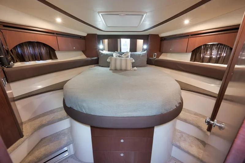 Slide: The Image of Luxurious interior of 2012 Meridian 441 Sedan yacht with elegant bedding and wood finishes. - 52