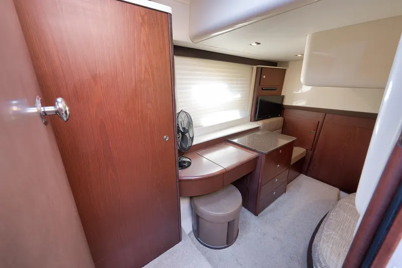 Slide: The Image of 2012 Meridian 441 Sedan interior with wood cabinetry, seating, and a small TV. - 57