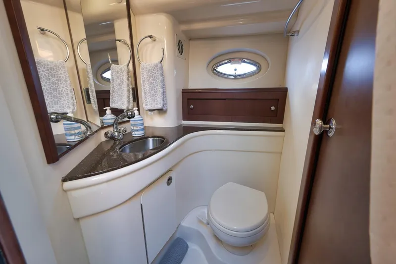 Slide: The Image of Luxurious bathroom in 2012 Meridian 441 Sedan yacht with modern fixtures and porthole window. - 59