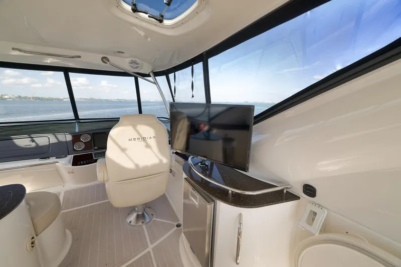 Slide: The Image of Interior of 2012 Meridian 441 Sedan yacht with helm, seating, and TV. - 60