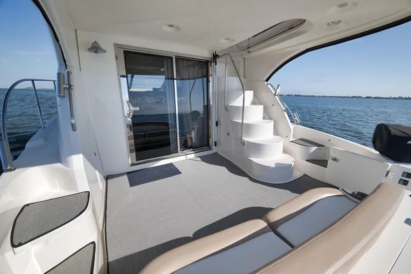 Slide: The Image of 2012 Meridian 441 Sedan yacht interior with elegant seating and ocean view. - 63