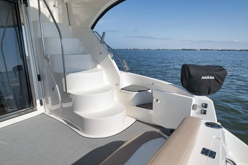 Slide: The Image of 2012 Meridian 441 Sedan yacht deck with stairs, overlooking serene ocean view. - 67