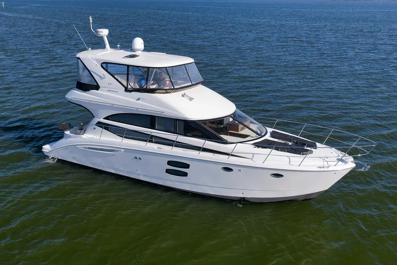 Slide: The Image of 2012 Meridian 441 Sedan yacht cruising on open water. - 7