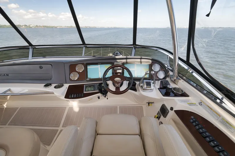 Slide: The Image of 2012 Meridian 441 Sedan helm with modern navigation controls and panoramic water view. - 72