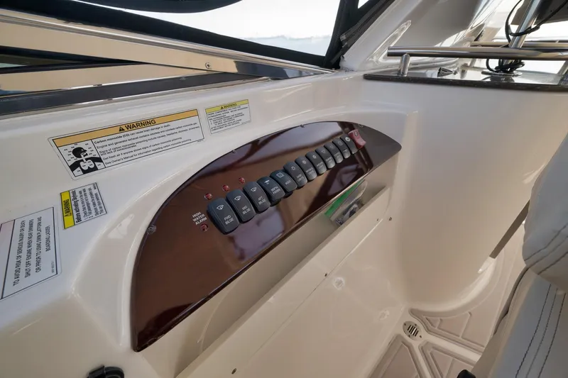 Slide: The Image of Control panel of a 2012 Meridian 441 Sedan yacht with warning labels. - 76