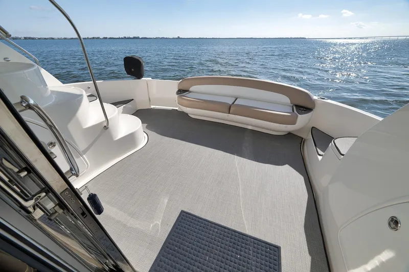 Slide: The Image of 2012 Meridian 441 Sedan yacht deck with seating, overlooking serene ocean view. - 78