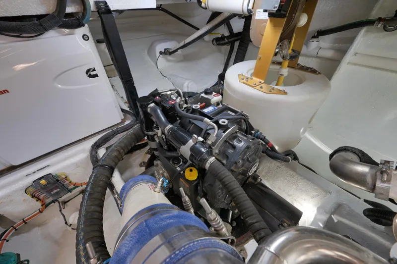 Slide: The Image of Engine room of 2012 Meridian 441 Sedan yacht, showcasing mechanical components and wiring. - 84