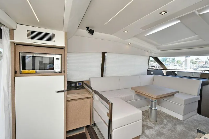 Slide: The Image of Luxurious interior of 2019 Prestige 460 yacht with modern seating and kitchenette. - 11
