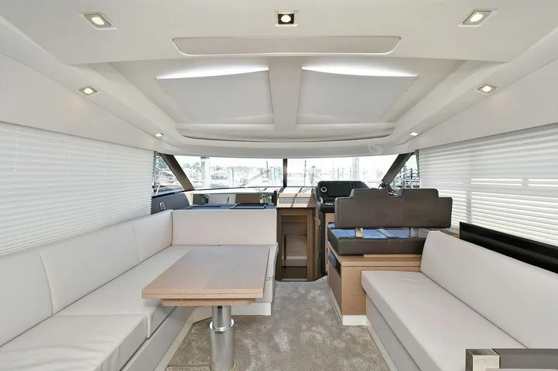Slide: The Image of Luxurious interior of 2019 Prestige 460 yacht with modern seating and dining area. - 12
