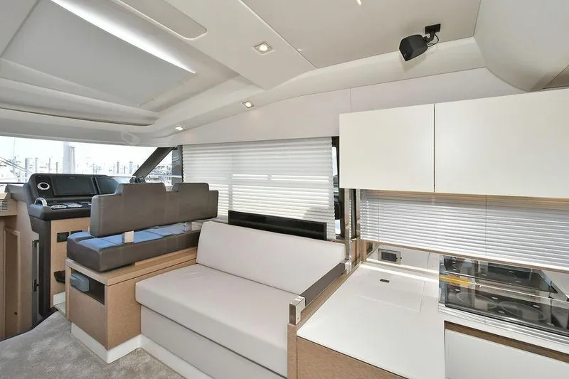 Slide: The Image of Luxurious interior of 2019 Prestige 460 yacht with modern seating and kitchen area. - 15