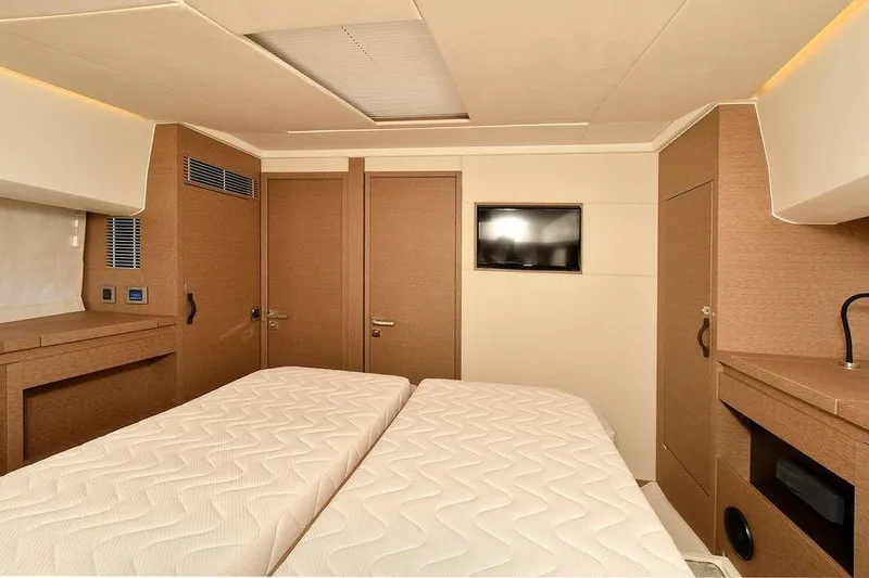 Slide: The Image of Interior of 2019 Prestige 460 yacht cabin with twin beds and modern decor. - 24
