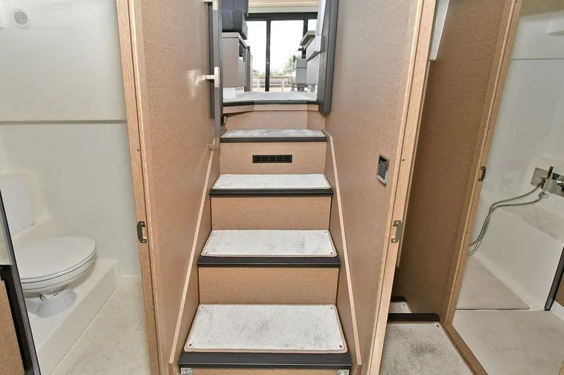 Slide: The Image of Interior of 2019 Prestige 460 yacht showing stairs, bathroom, and modern design elements. - 25