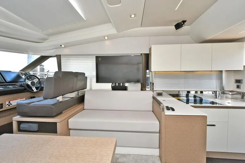 Slide: The Image of Luxurious interior of 2019 Prestige 460 yacht with modern seating and sleek kitchen design. - 31