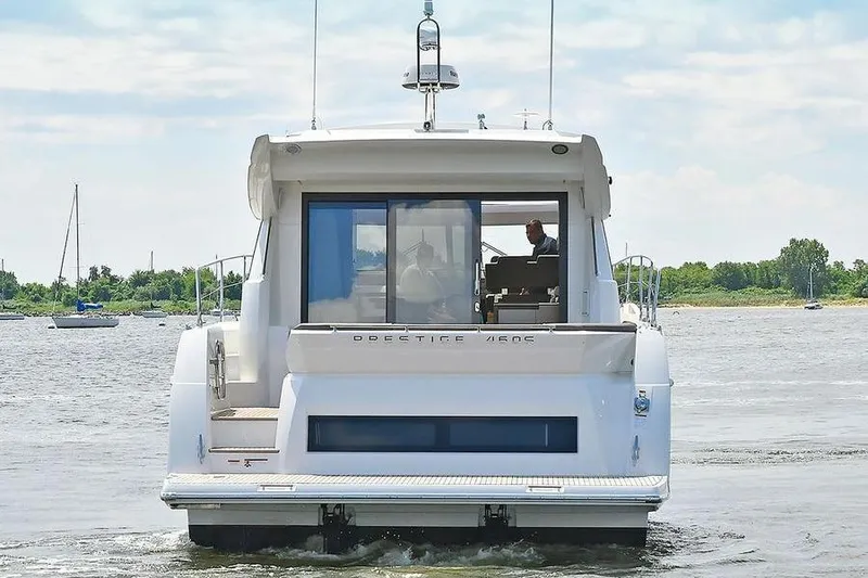 Slide: The Image of 2019 Prestige 460 yacht cruising on a calm river with scenic background. - 4