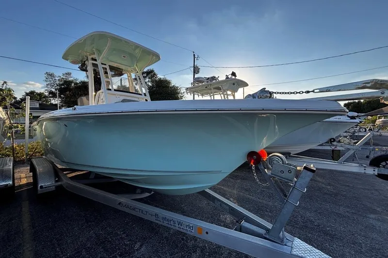 Slide: The Image of 2021 Key West 239 FS boat on trailer, parked outdoors under clear sky. - 6