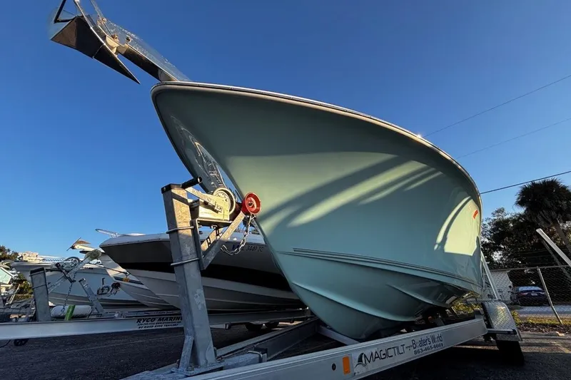 Slide: The Image of 2021 Key West 239 FS boat on trailer under clear blue sky. - 9