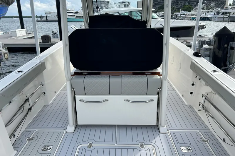 Slide: The Image of 2023 Pursuit S 288 Sport boat interior at marina, featuring sleek seating and modern design. - 12