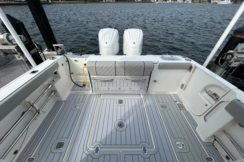 Slide: The Image of 2023 Pursuit S 288 Sport boat deck with dual engines, spacious layout, and sleek design. - 14